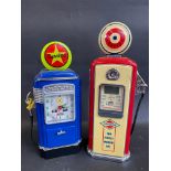 Two contemporary and decorative clocks in the shape of petrol pumps.