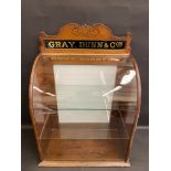 A counter top dispensing cabinet for Gray, Dunn & Co's biscuits, with glass pediment and rear