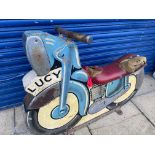 A fairground wooden motorbike from an ark ride, circa 1950s/1960s, with 'Lucy' painted on the side.