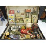 A large travelling trunk containing an assortment of tins.