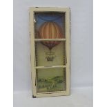 A decorative three panel wooden framed window with a colourful design to the glass in the manner