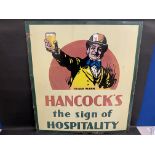 A large Hancock's ales pictorial enamel sign depicting a man holding up a glass of beer, 35 1/2 x 39