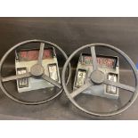 Two steering wheels from a fairground driving game.