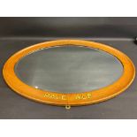 A Whitbread's Pale Ale bevel edged oval mirror in wooden frame, lettered to advertise the brand,