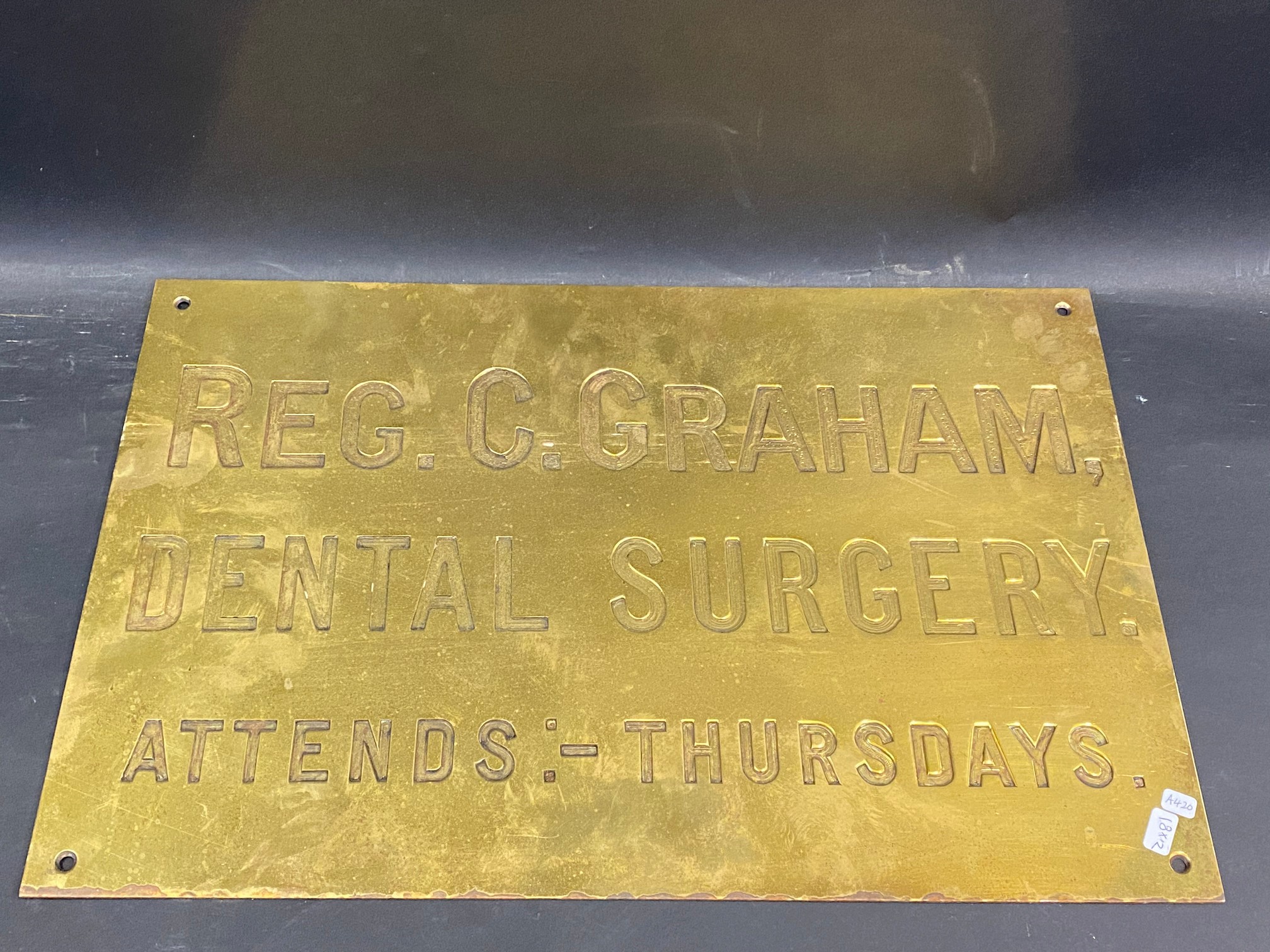 A brass name plaque for 'Reg. C. Graham Dental Surgery', 18 x 12".