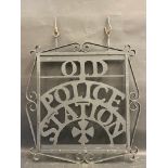 A die-cut metal hanging sign for 'Old Police Station', 23 1/2 x 27" (to tip of hanging loops).