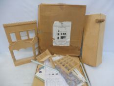 A boxed wooden model of a Victorian shop, Honey Church dolls house kit, 1:12th scale, unchecked.