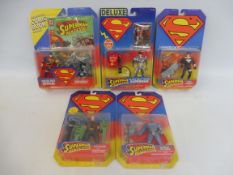 Five Kenner Superman carded figure and action sets, generally good condition.