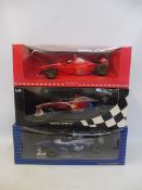 Three boxed 1:18 scale model F1 racing cars, including Williams Minichamp.