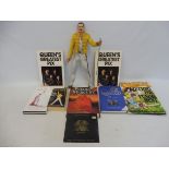 Queen books and memorabilia to include a Neca figure of a singing Freddie Mercury.