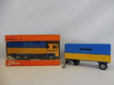 A boxed Tekno Scania truck with unboxed trailer.