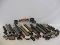 A quantity of playworn oo gauge rolling stock and carriages.