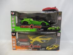 Two boxed Gear Max 1/16 scale modern racing vehicles comprising a Lamborghini and a McClaren.