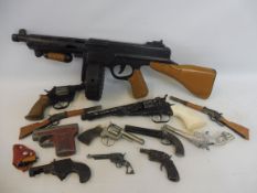 A Marx plastic tommy gun plus twelve other toy guns.