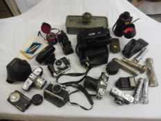 A box of assorted cameras etc.