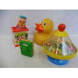 A Fisher Price Toys jack-in-the-box, an Italian Chicco spinning top, a Fisher Price music box and an