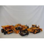 Three large scale Cat Caterpiller remote controlled construction vehicles.