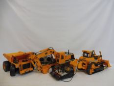 Three large scale Cat Caterpiller remote controlled construction vehicles.