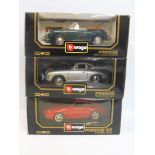 Three boxed Burago 1/18 scale models, all Porsches of different eras.