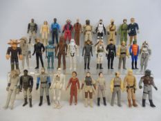 32 original release Star Wars figures, to include Chewbacca, Princess Leia, Walrus Man and others.