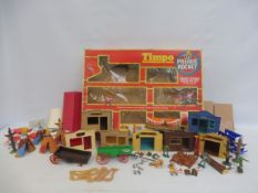 A selection of Timpo and Britains Wild West buildings, wagon, canoe etc in a Timpo Prairie Rocket