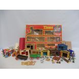 A selection of Timpo and Britains Wild West buildings, wagon, canoe etc in a Timpo Prairie Rocket