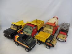 A tray of Tonka construction vehicles to include cement mixer, in two trays, also a car