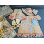 A selection of children's leather clothing, in the native American style.