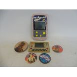 A small quantity of Star Wars memorabilia to include two handheld games, badges etc.