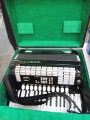 A Hohner accordian, in case, appears in excellent condition.