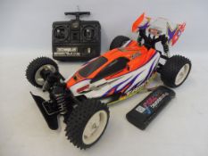 A Tamiya Rising Storm 1:10th scale remote controlled buggy, with a battery and Techiplus radio