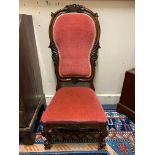 A Victorian mahogany framed show wood upholstered nursing chair, raised upon castors, 44" h.