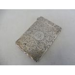 A silver card case with all-over chased decoration and central intials, Chester 1898, maker AC &