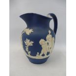 A 19th Century Wedgwood blue and white jasperware jug, 6" h.