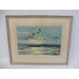 PETER SCOTT - a framed and glazed print of birds (probably geese) in flight, signed in pencil by