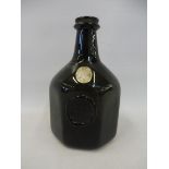 An 18th Century style octagonal green glass bottle, with seal for Jno. Greenhow WmsBurg, 1770, and