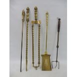 A pair of good quality 19th Century brass fire irons, of twisted form, plus an associated poker,