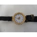 A high quality yellow metal, probably at least 15ct gold ladies wristwatch, the circular white