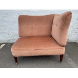 An unusual Edwardian upholstered two sided corner settee raised upon square tapering supports.