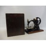 A Wilcox & Gibbs sewing machine, of unusual ornate form, with inset medallion to the base, in a