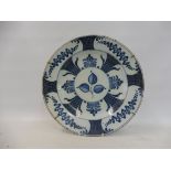 A large probably 18th Century Delft blue and white charger, 13 1/2" diameter.