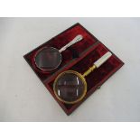 A very good quality gilded brass and MOP inlaid magnifying glass, set in it's original red velvet