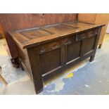 An 18th Century oak coffer of good colour with a three panelled rising lid, the front with a