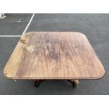 A William IV mahogany tilt top breakfast/dining table raised upon a quatrefoil base, the top