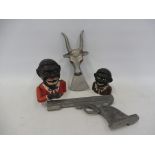 Two cast iron money boxes, a boot remover in the form of a mythical creature and a metal model of