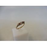 A 9ct gold dress ring set with pink and clear stones, size N/O, 2g.