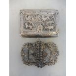 An Indian white metal cigarette case, with decoration in deep relief plus a white metal two piece