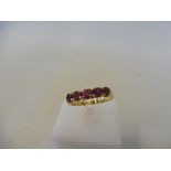 A cased French gold and ruby set ring, size L/M, 3.4g.
