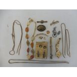 A selection of assorted jewellery including a yellow metal crescent shaped brooch set with seed