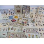 A selection of cigarette cards in albums, plus large and small silks including King George V.